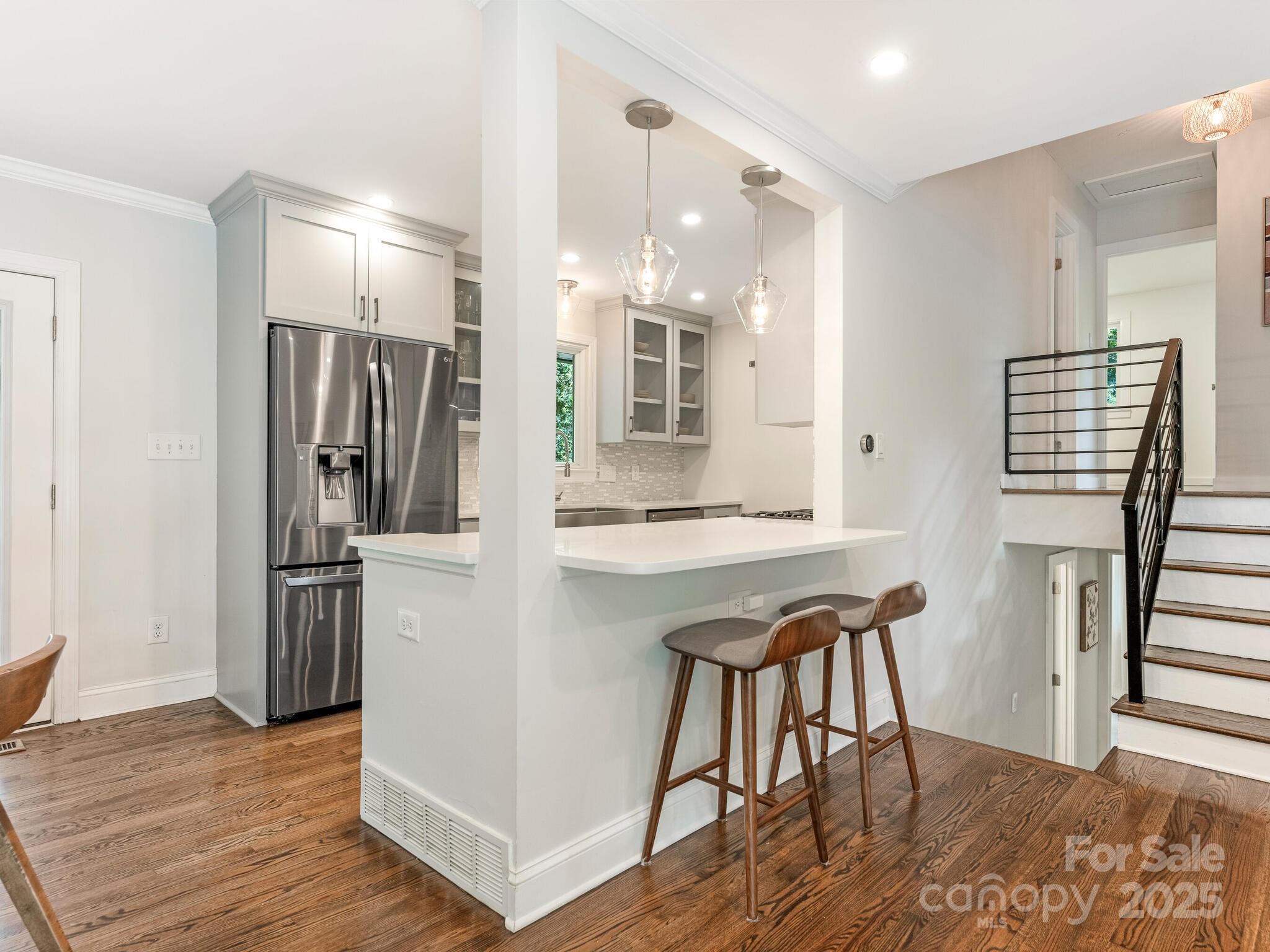 4901 Murrayhill Road Charlotte, NC 28209 - Photo 7 of 28 a kitchen with stainless steel appliances granite countertop a refrigerator and a stove top oven