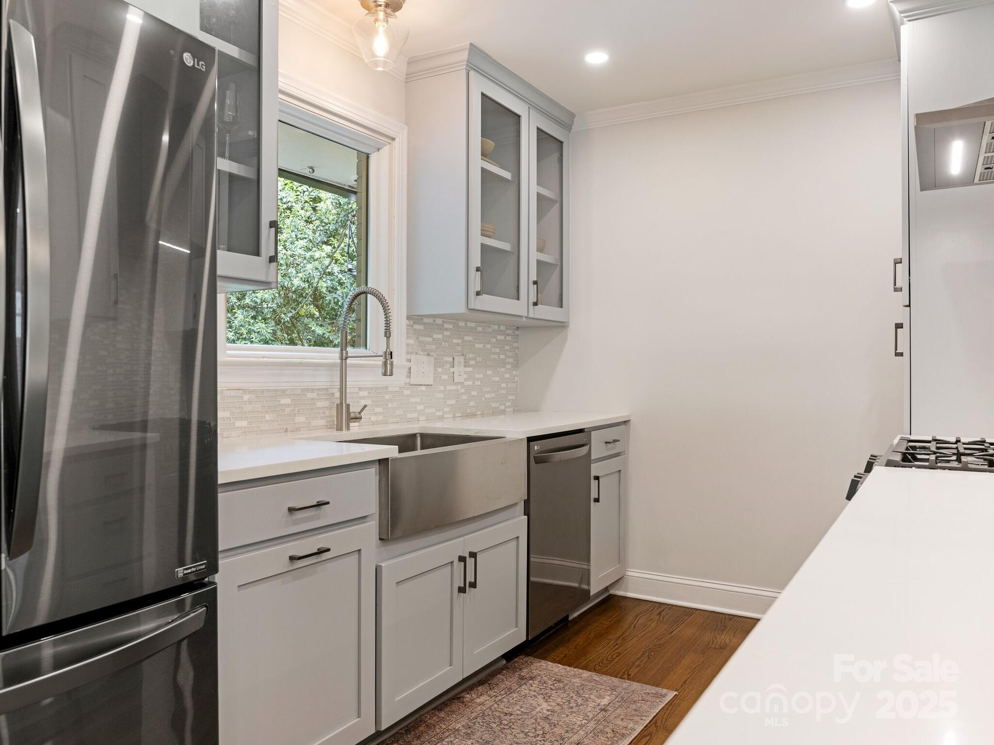 4901 Murrayhill Road Charlotte, NC 28209 - Photo 9 of 28 a kitchen with stainless steel appliances granite countertop a refrigerator and a sink