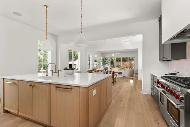 a stove top oven sitting inside of a kitchen