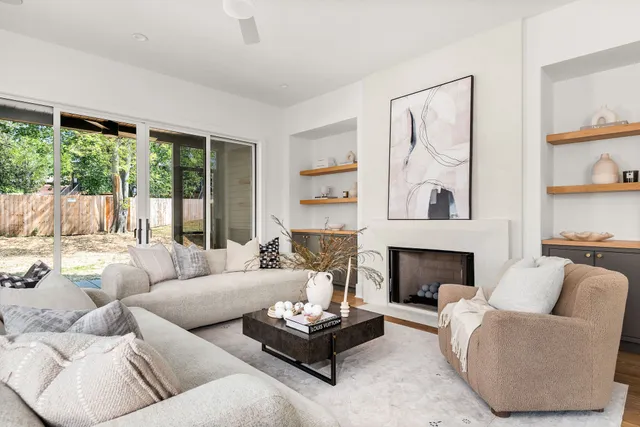a living room with furniture and a fireplace