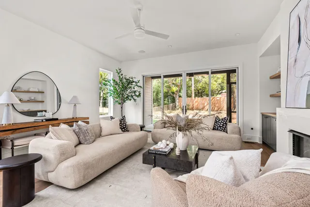 a living room with furniture and a wooden floor