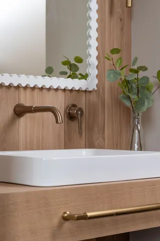 a spacious bathroom with a double vanity sink a large mirror and a bathtub next to a window