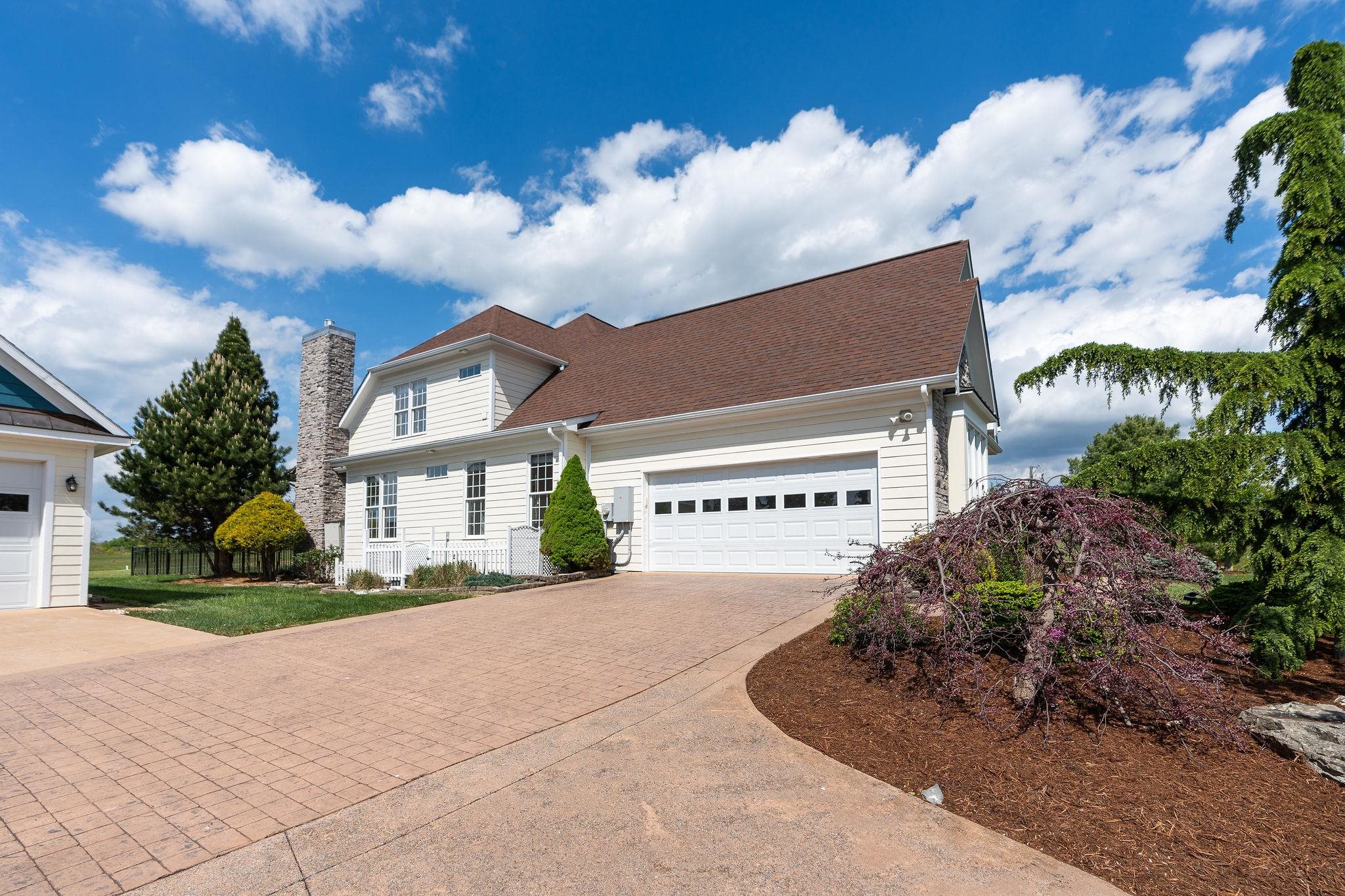 12 Ridgemore Drive Raphine, VA 24472 - Photo 61 of 75 a front view of a house with a yard and garage