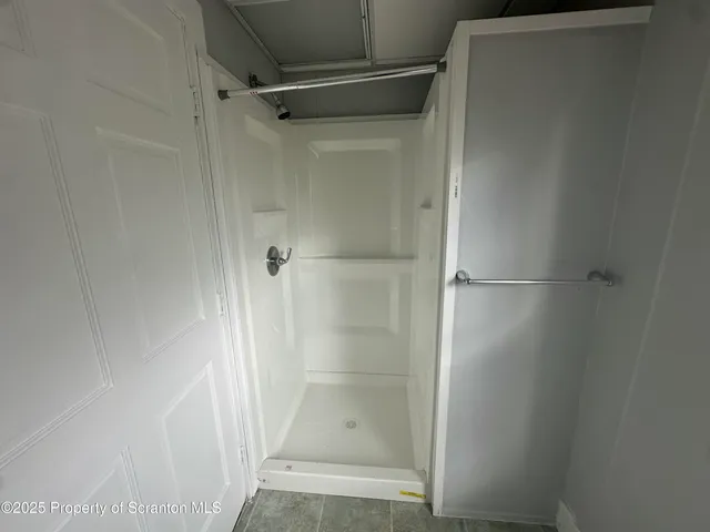 a bathroom with a glass door shower