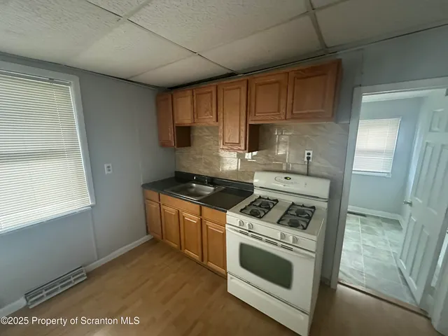 a kitchen with a stove and a sink