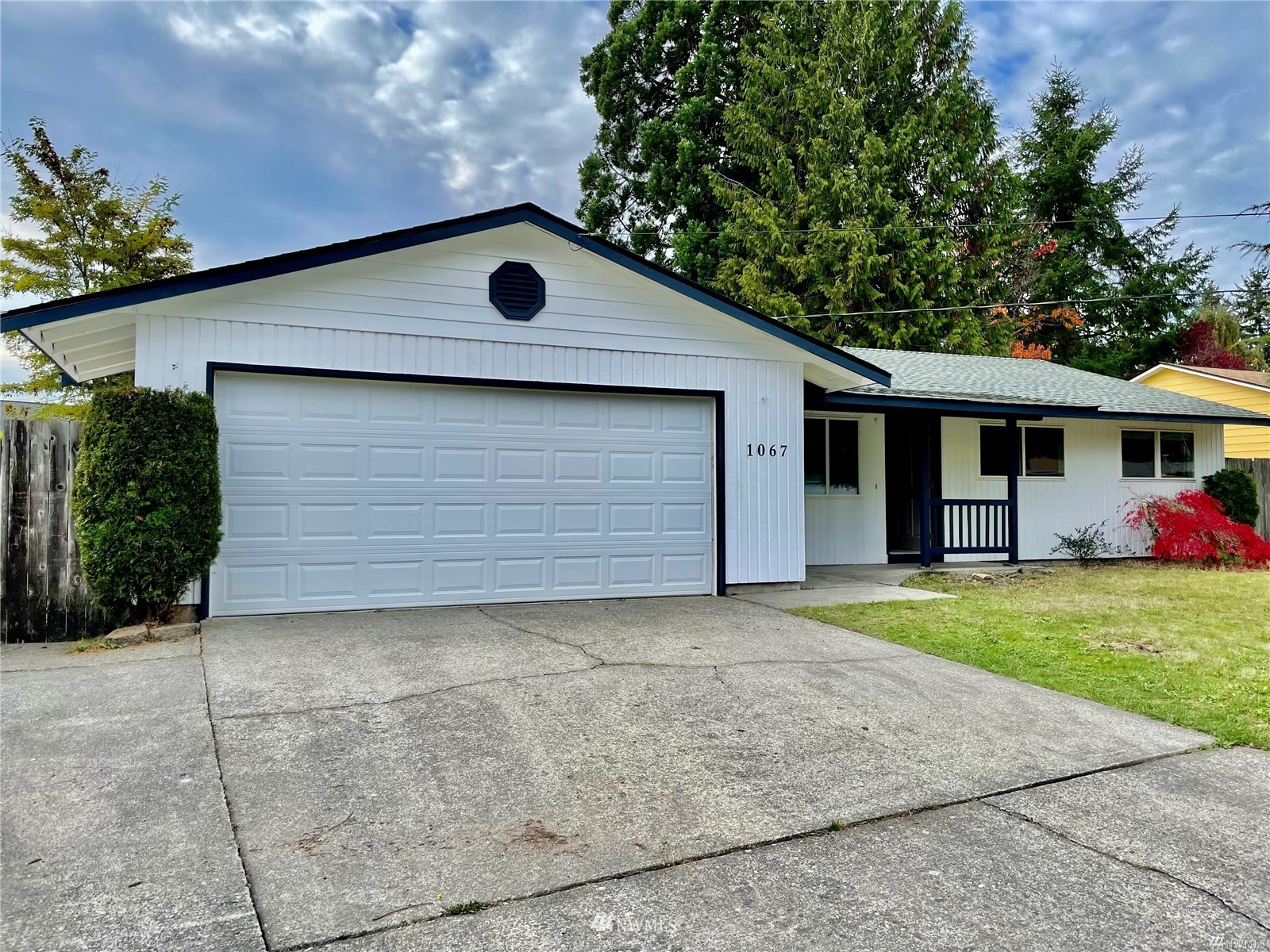 1067 Anacortes Avenue Northeast Renton, WA 98059 - Photo 1 of 18 a front view of a house with a yard and garage