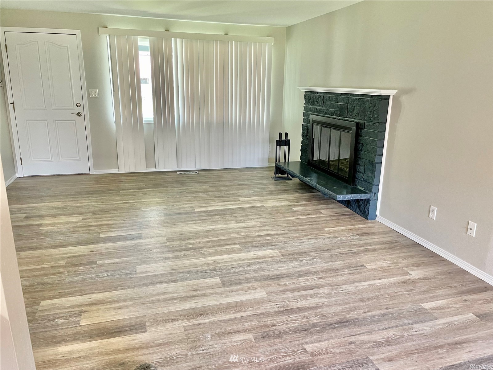 1067 Anacortes Avenue Northeast Renton, WA 98059 - Photo 4 of 18 a view of empty room with fireplace and wooden floor