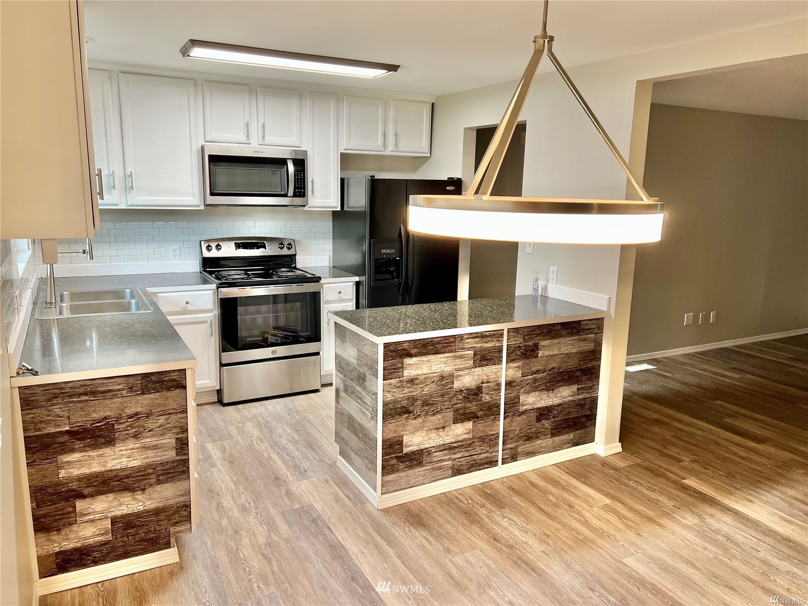 1067 Anacortes Avenue Northeast Renton, WA 98059 - Photo 6 of 18 a kitchen with wooden cabinets and a stove top oven