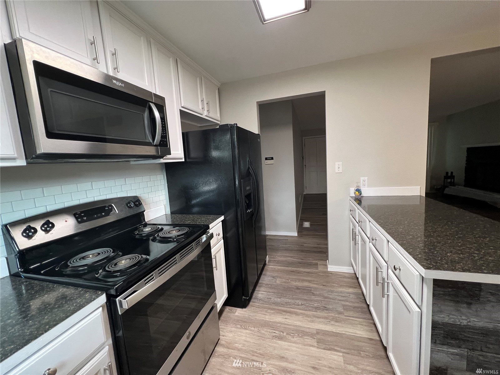 1067 Anacortes Avenue Northeast Renton, WA 98059 - Photo 7 of 18 a kitchen with a stove microwave and sink