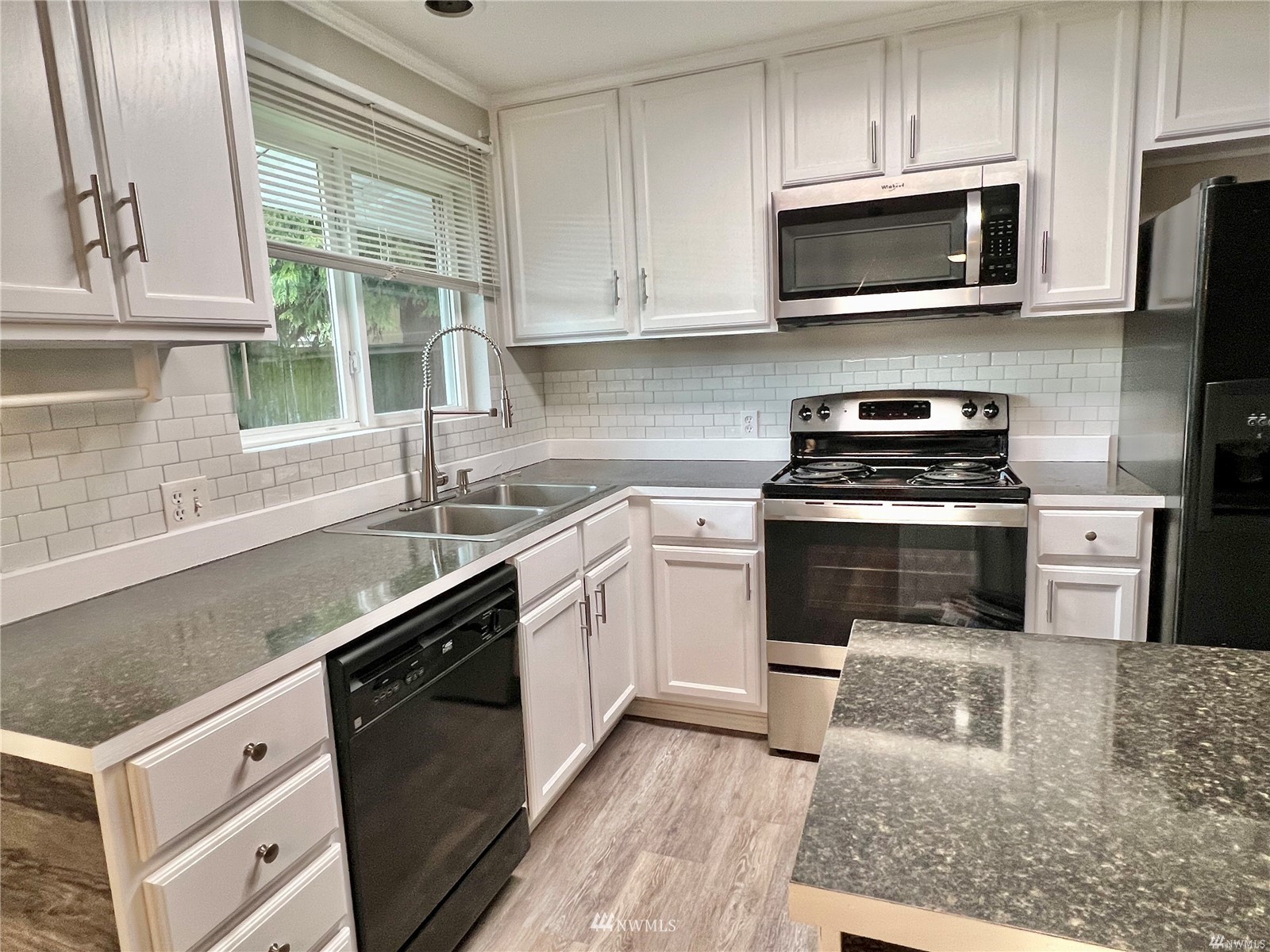 1067 Anacortes Avenue Northeast Renton, WA 98059 - Photo 8 of 18 a kitchen with a sink stove and microwave