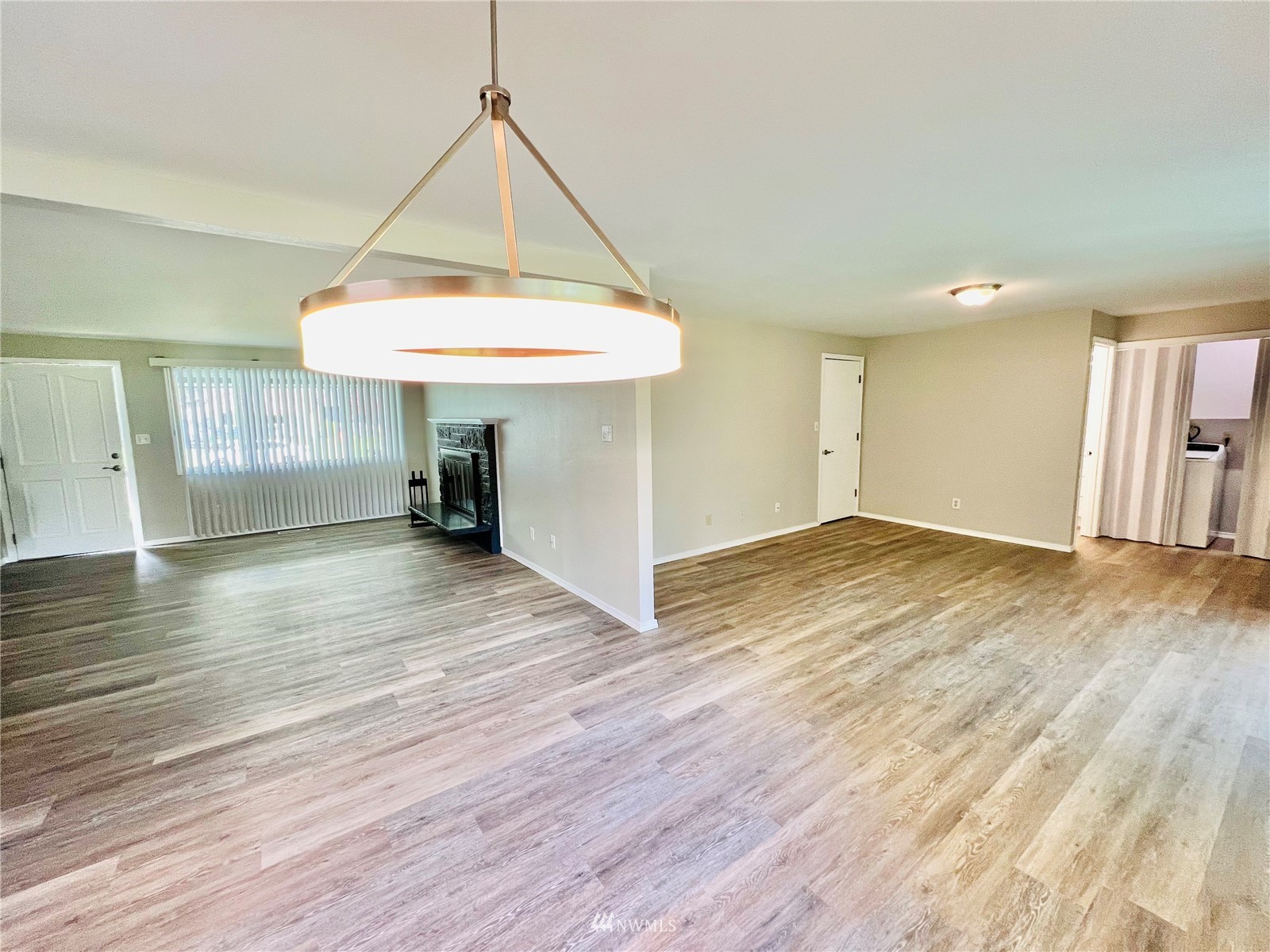 1067 Anacortes Avenue Northeast Renton, WA 98059 - Photo 9 of 18 wooden floor in an empty room with a window