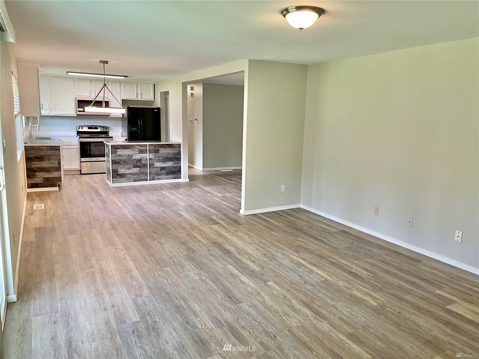 1067 Anacortes Avenue Northeast Renton, WA 98059 - Photo 10 of 18 a view of a kitchen with wooden floor