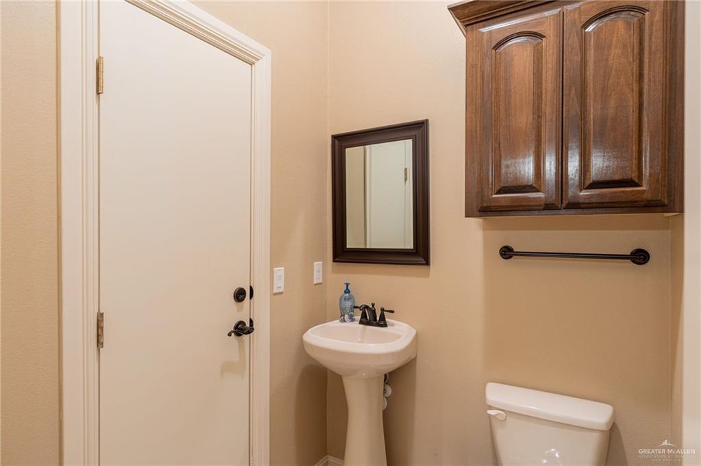 2112 Kilgore Avenue McAllen, TX 78504 - Photo 12 of 19 a bathroom with a sink a toilet and mirror