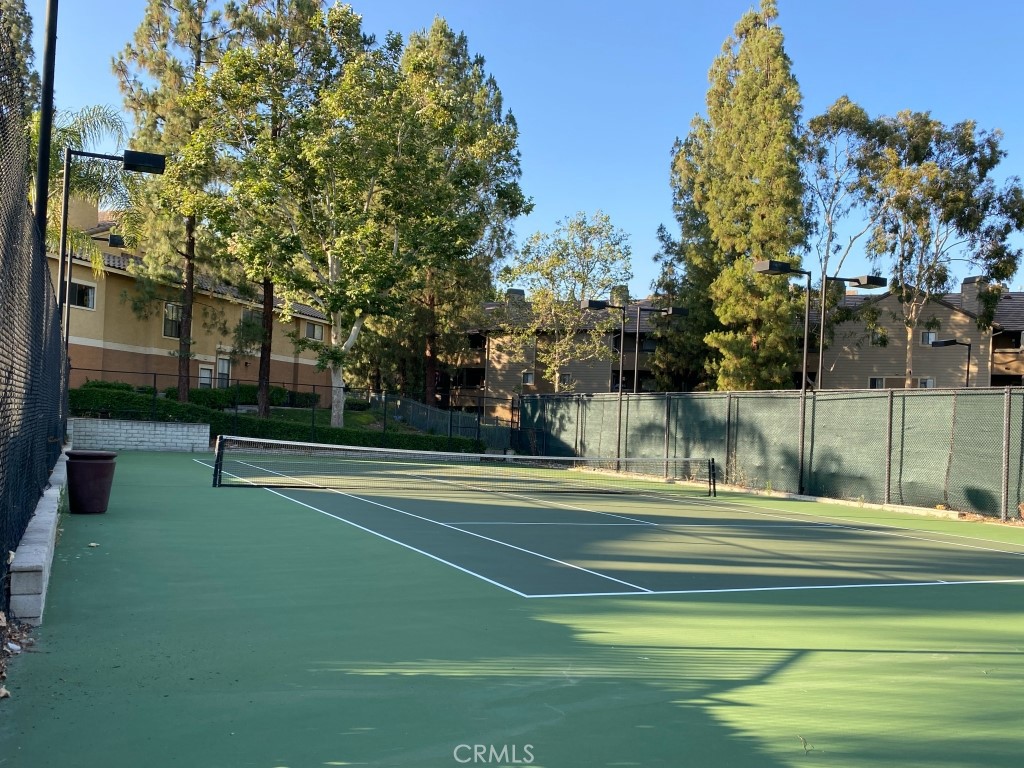 10655 Lemon Avenue, Unit 3509 Rancho Cucamonga, CA 91737 - Photo 14 of 15 a view of a tennis ground with large trees