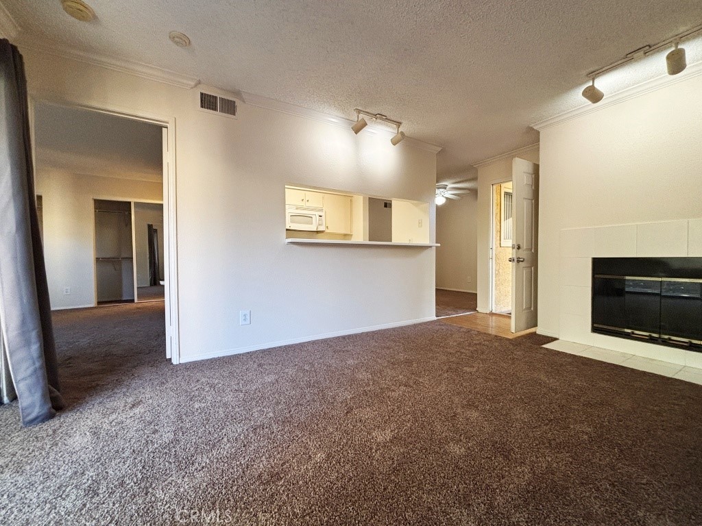 10655 Lemon Avenue, Unit 3509 Rancho Cucamonga, CA 91737 - Photo 4 of 15 a view of empty room with a fireplace