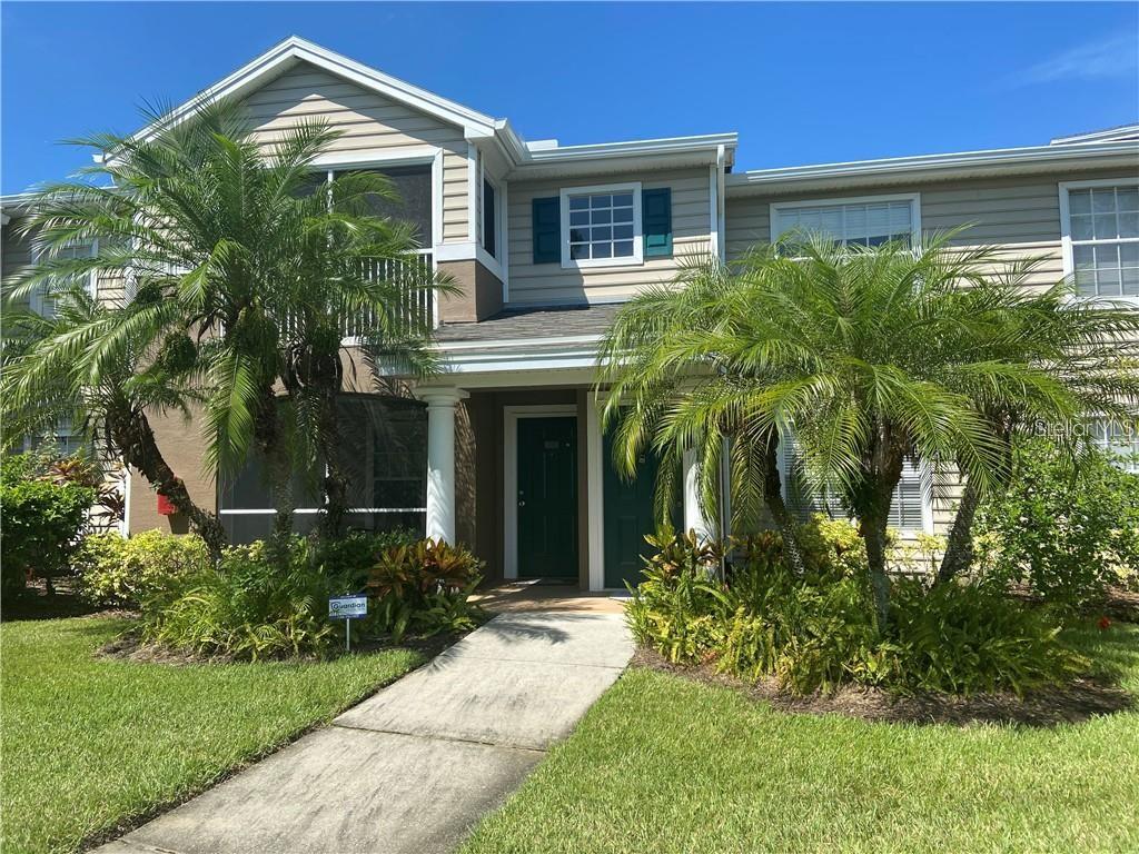8923 Manor Loop, Unit 206 Lakewood Ranch, FL 34202 - Photo 1 of 1 a front view of a house with a yard