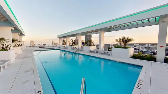 a spacious bedroom with a bed and a chandelier
