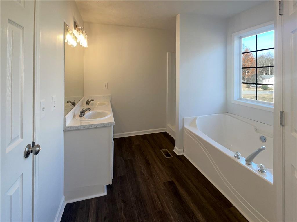 16 Fairview Glen Dallas, GA 30157 - Photo 6 of 26 a bathroom with a tub sink and mirror