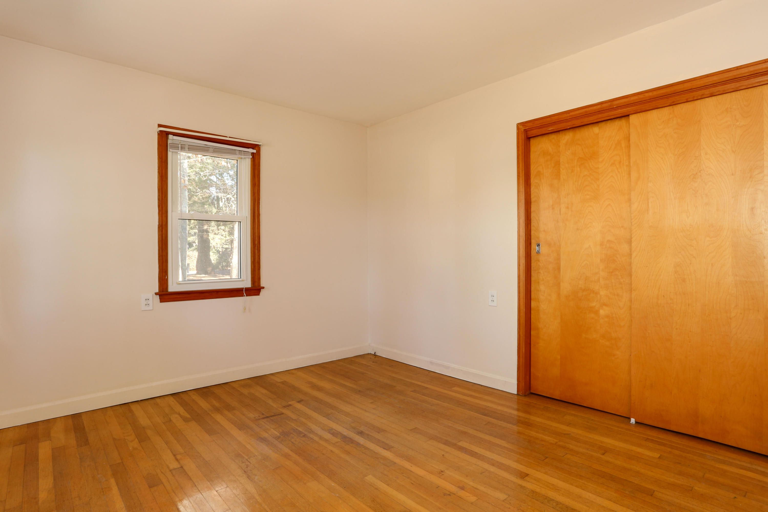 625 Poponessett Road Cotuit, MA 02635 - Photo 14 of 32 a view of an empty room with wooden floor and a window