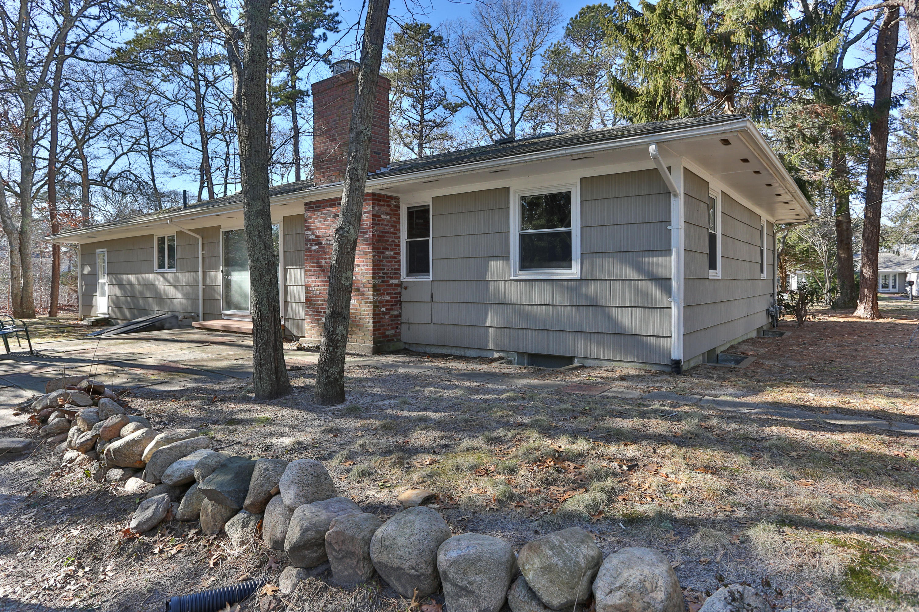 625 Poponessett Road Cotuit, MA 02635 - Photo 21 of 32 a view of a house with a yard