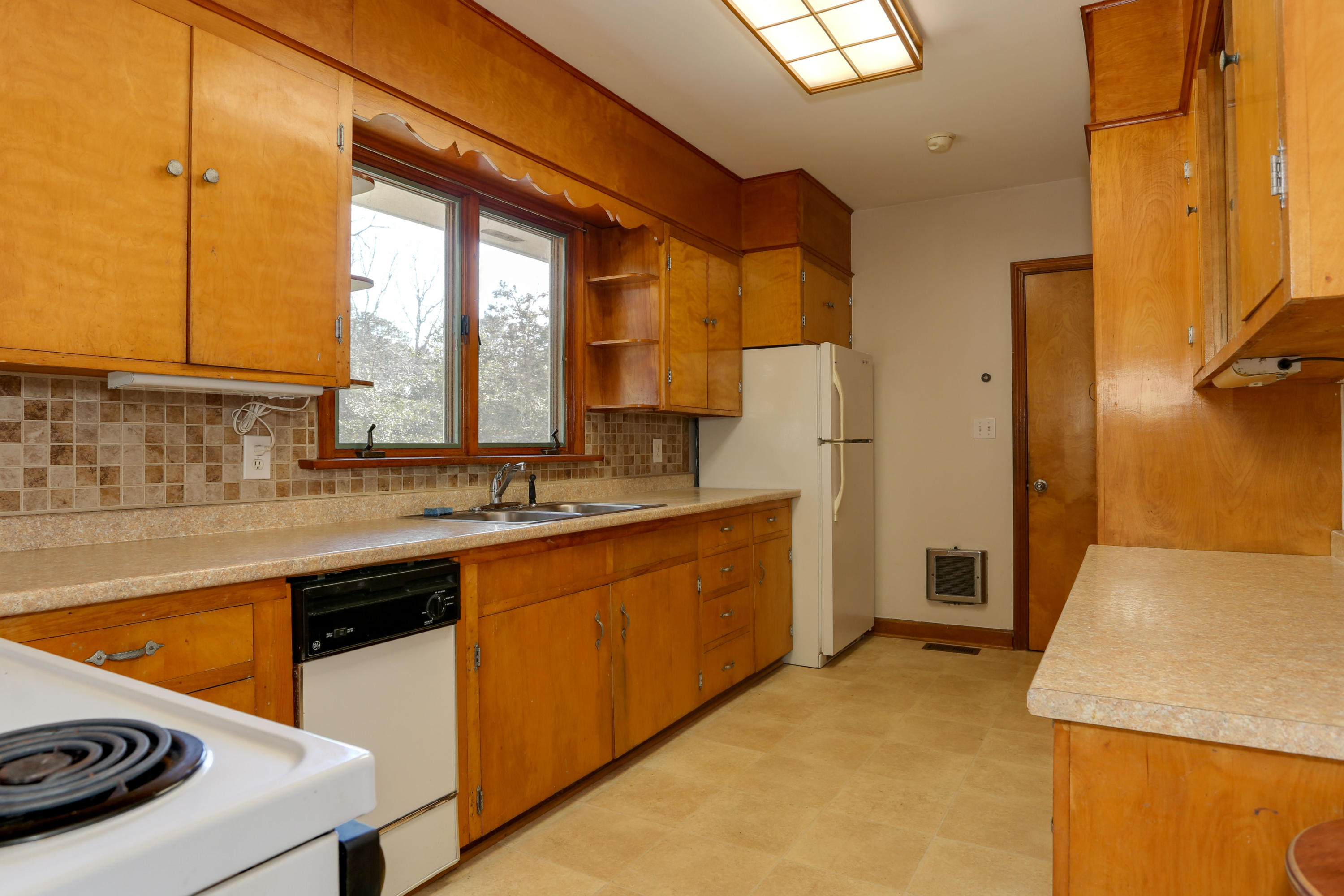 625 Poponessett Road Cotuit, MA 02635 - Photo 8 of 32 a kitchen with stainless steel appliances a sink a stove and a refrigerator