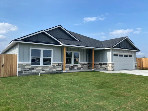 a front view of house with a garden and patio