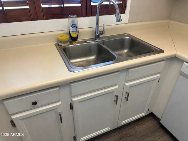a view of a small space with wooden floor and a window