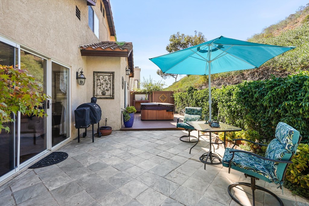1848 Loreto Glen Escondido, CA 92027 - Photo 7 of 43 a patio with a table and chairs under an umbrella
