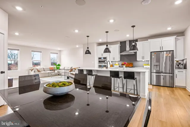 a kitchen with a sink a stove and chairs