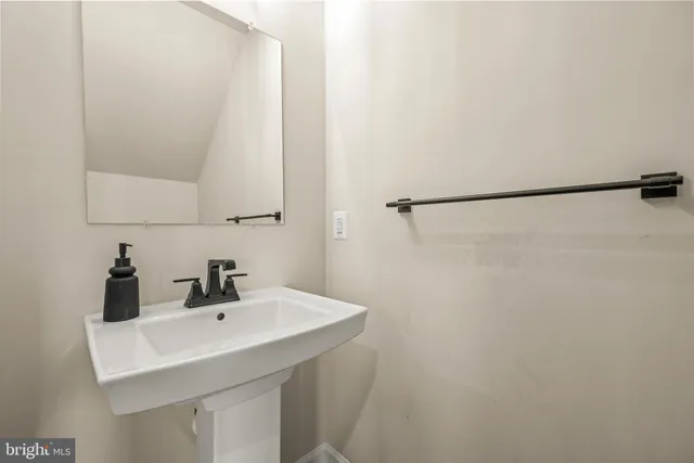 a bathroom with a sink and mirror