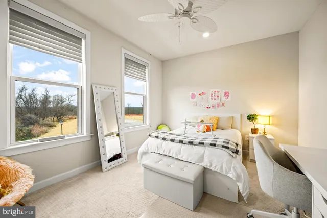 a bedroom with a bed and a large window with the outer view
