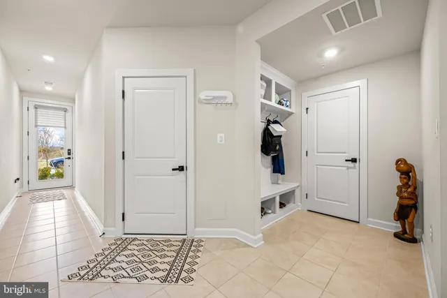 a view of a hallway with closet and entryway