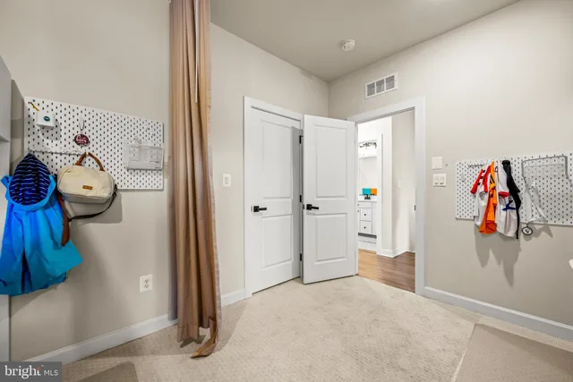 a bathroom with a double vanity sink toilet mirror and shower