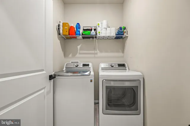 a bedroom with a bed and a flat tv screen on dresser