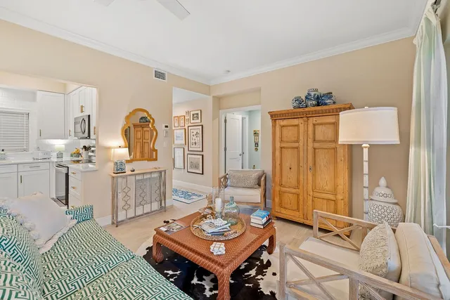 a living room with furniture a rug and a table