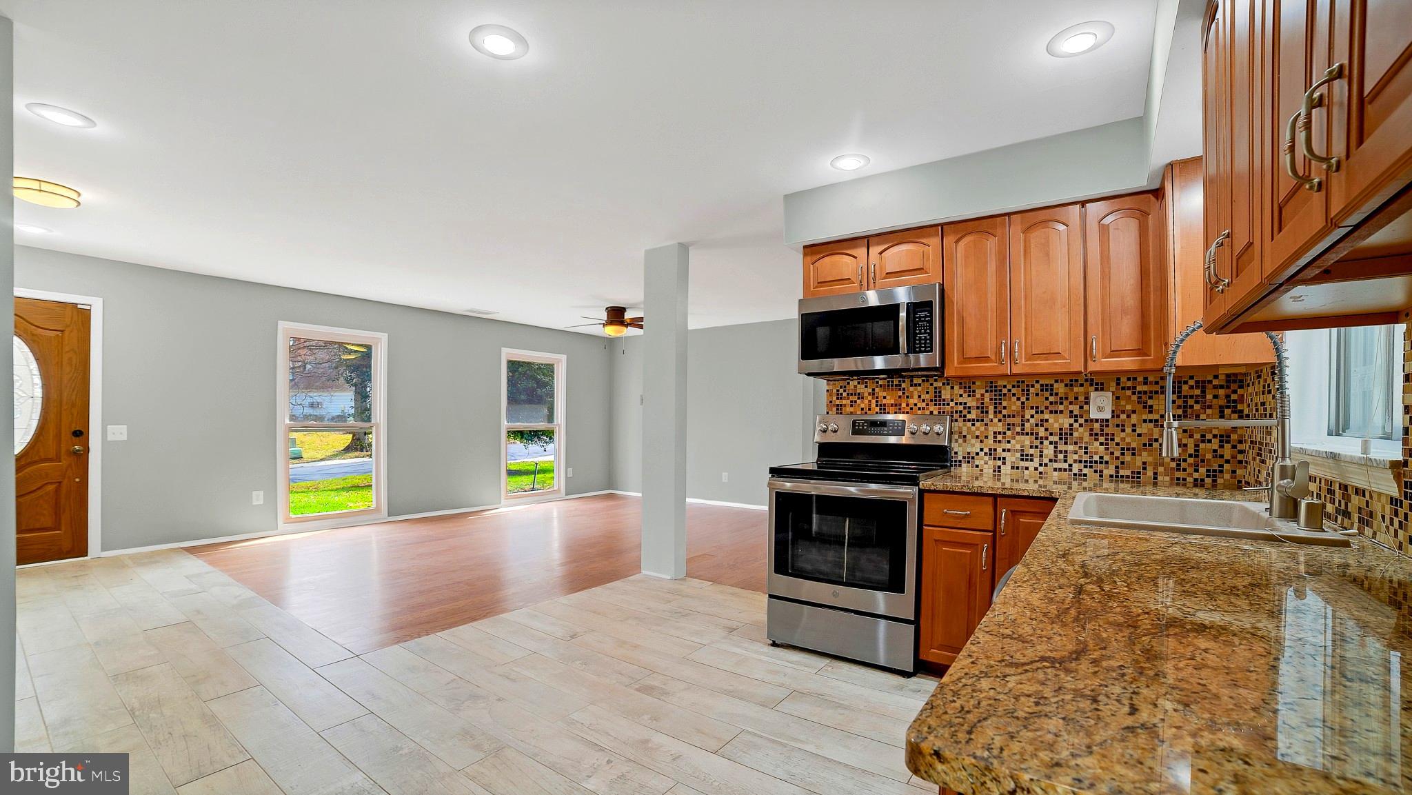 Granite Counters, Tile Flooring. Ample Cabinets