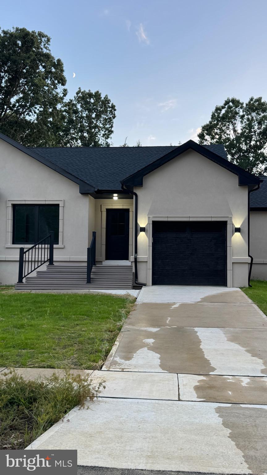 340 Honeymoon Road Glassboro, NJ 08028 - Photo 9 of 110 a front view of a house with a yard and garage