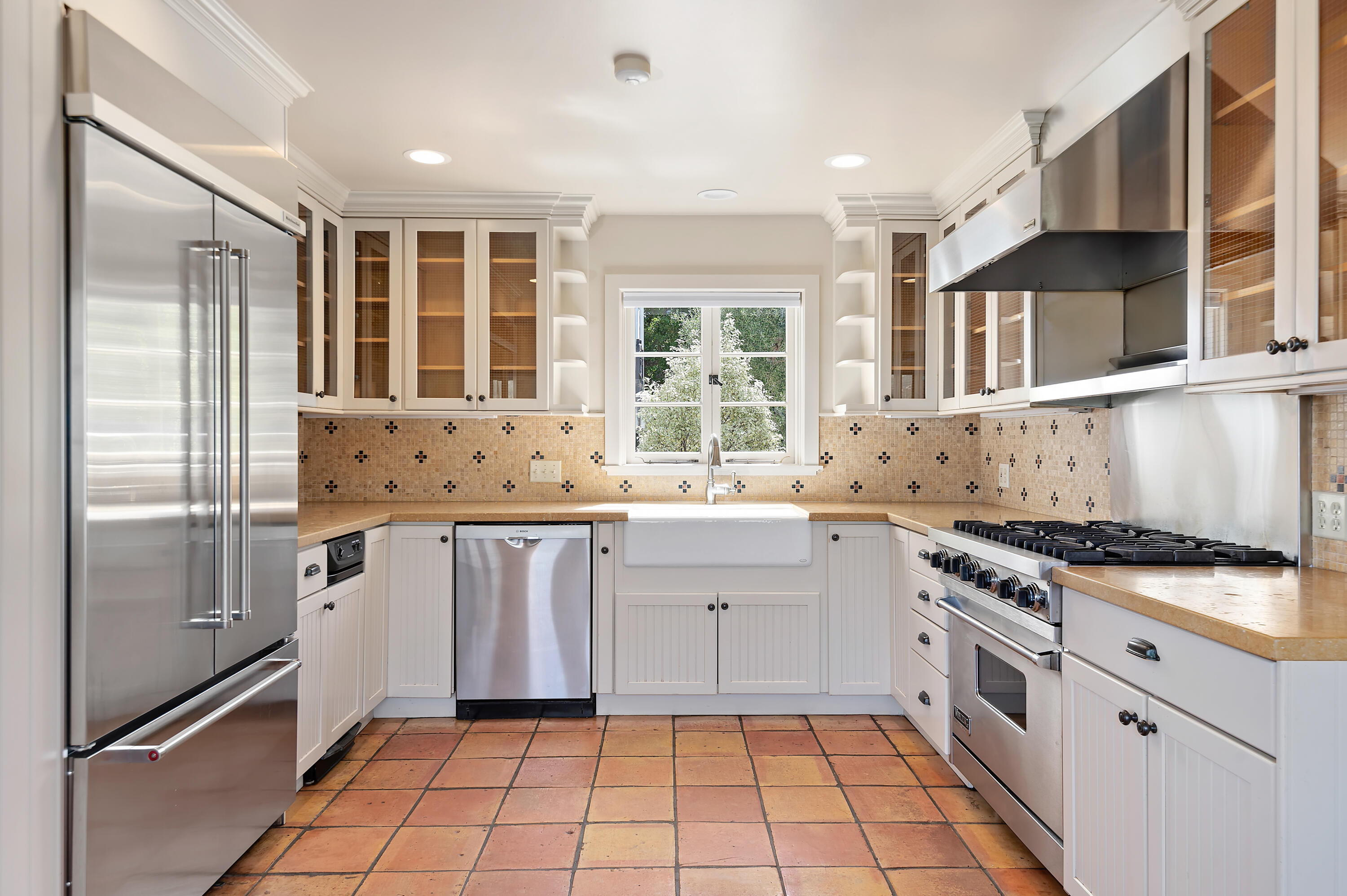 931 Knapp Drive Santa Barbara, CA 93108 - Photo 14 of 40 a kitchen with granite countertop a stove top oven sink and cabinets