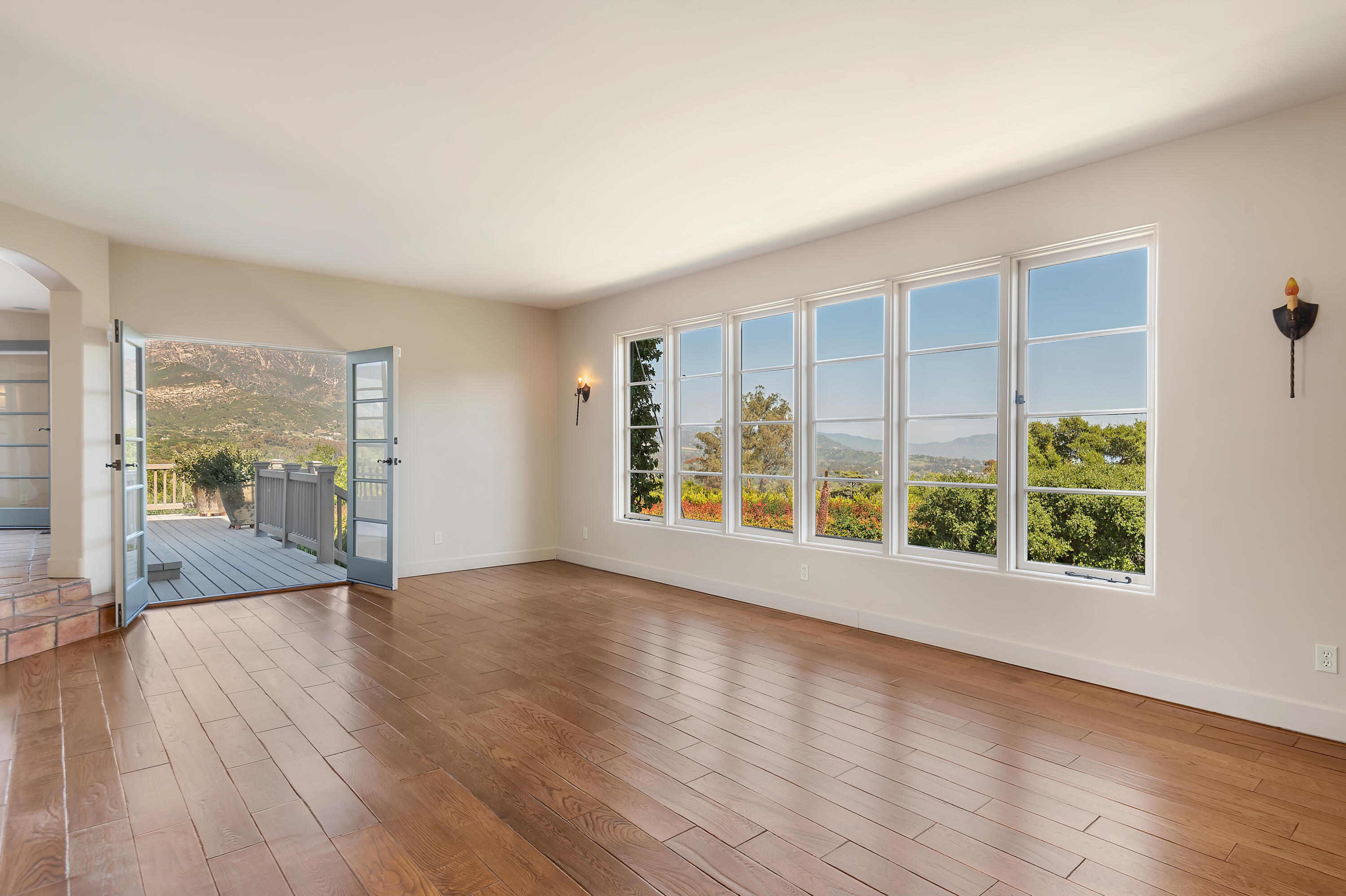 931 Knapp Drive Santa Barbara, CA 93108 - Photo 4 of 40 a view of an empty room with wooden floor and a window