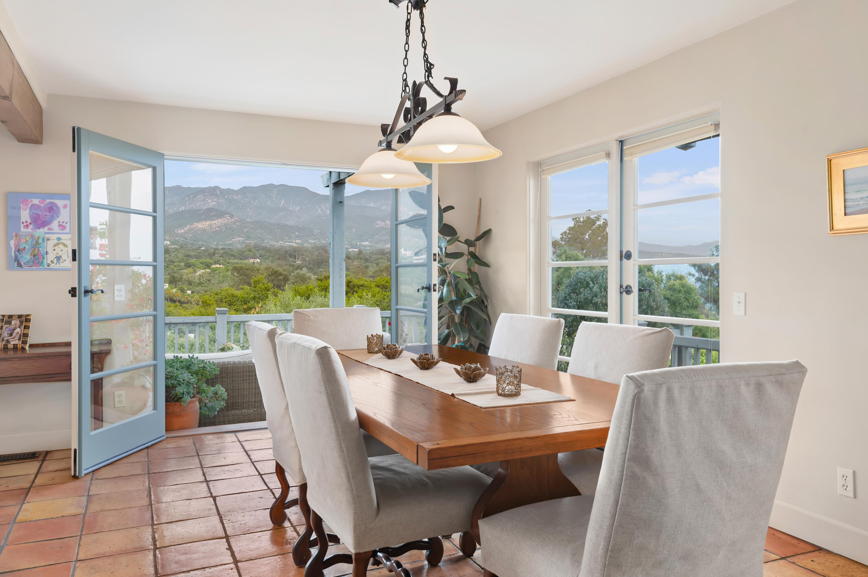 931 Knapp Drive Santa Barbara, CA 93108 - Photo 8 of 40 a view of a dining room with furniture large windows and wooden floor