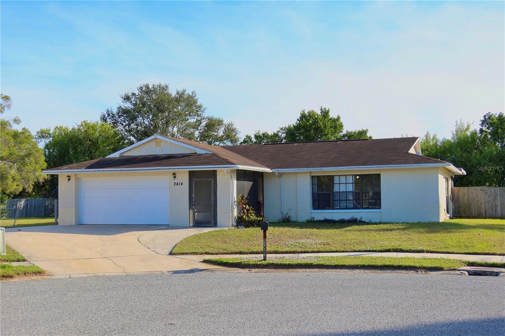 2414 San Luis Road Holiday, FL 34691 - Photo 1 of 1 a front view of a house with a yard and garage