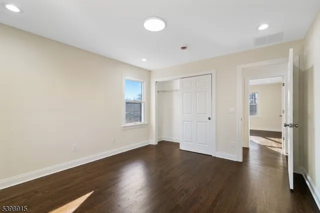 a view of a room with wooden floor and window