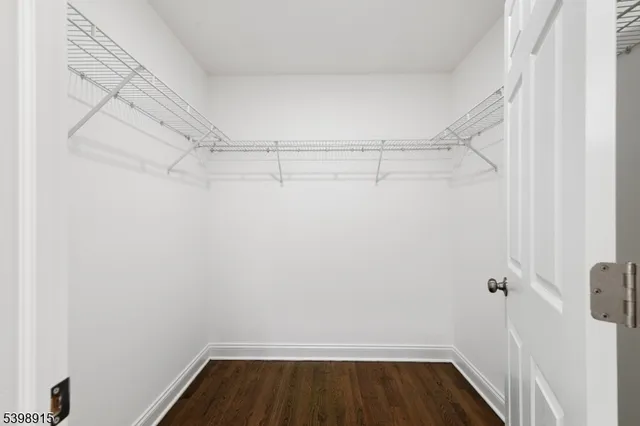 a view of storage and utility room with wooden floor