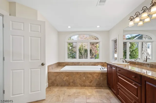a large bathroom with a large tub and sink