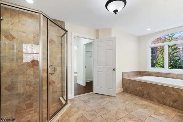 a bathroom with a tub and shower