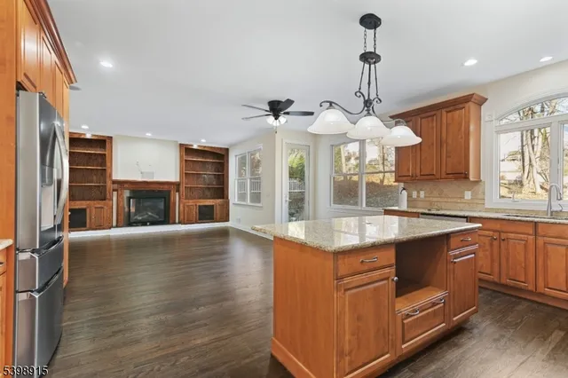 a large kitchen with stainless steel appliances granite countertop a stove and a sink
