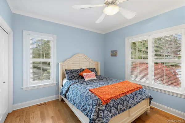 a bedroom with a large bed and a window