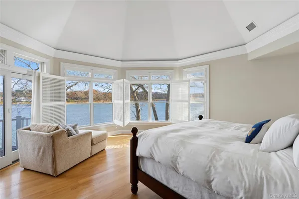 a spacious bedroom with a bed and a large window
