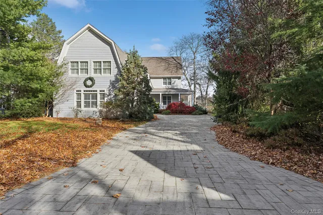 a view of a big house with a yard and large trees