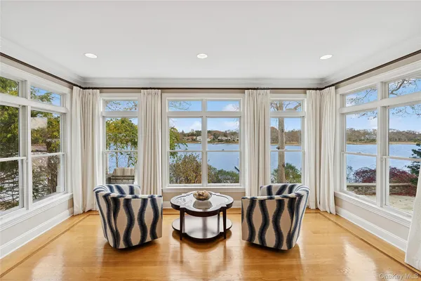 a living room with furniture and floor to ceiling windows